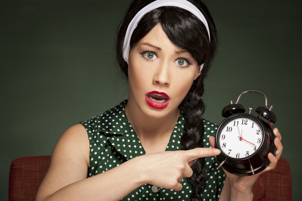 Retro housewife holding an alarm clock